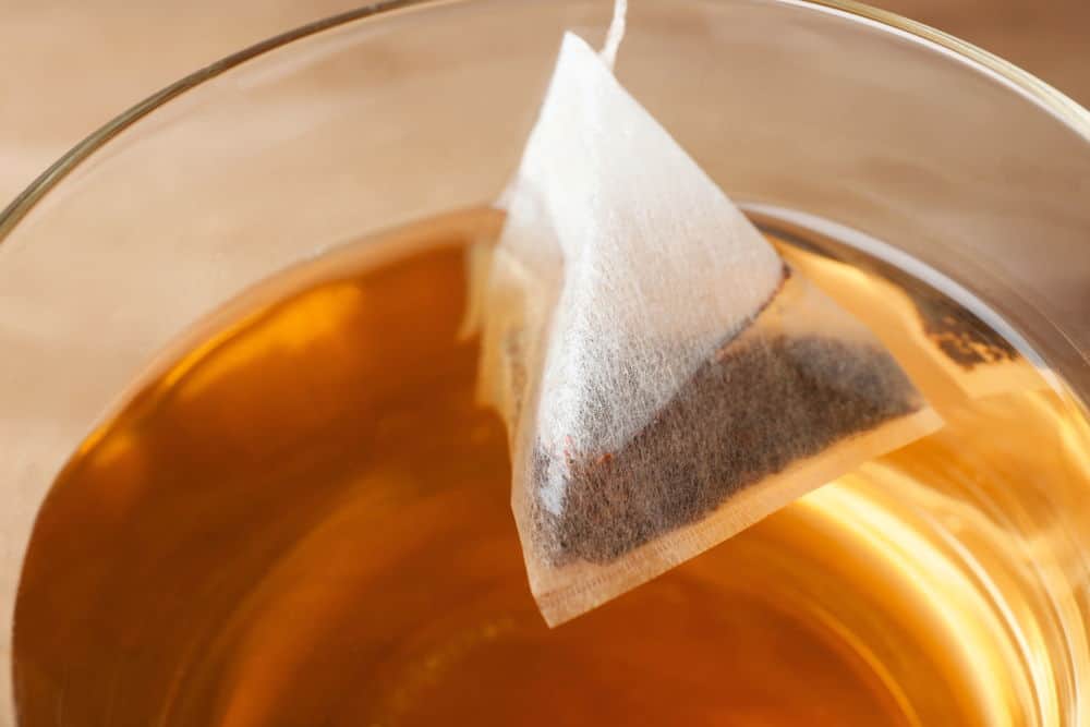 teabag in cup with hot fresh drink