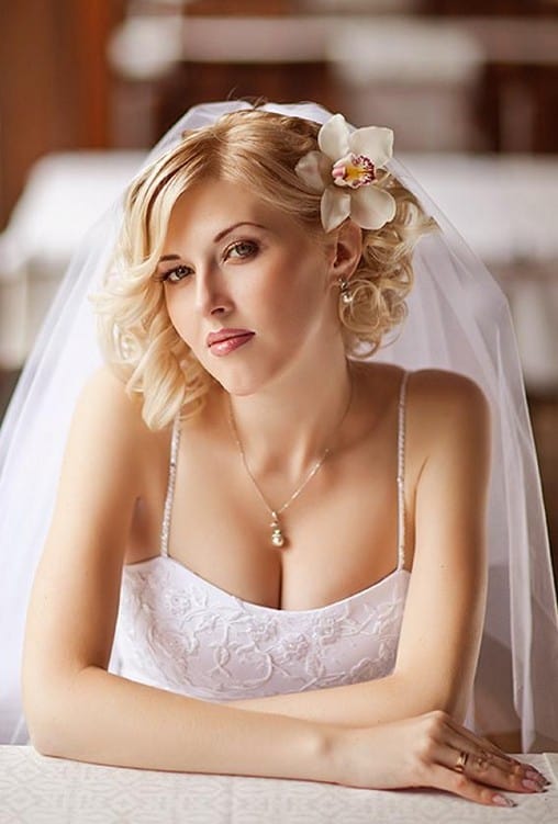 Curly Wedding Hairstyle with an Orchid